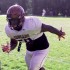 Derrick runs in to get to the blocker to get through to make the tackle.
