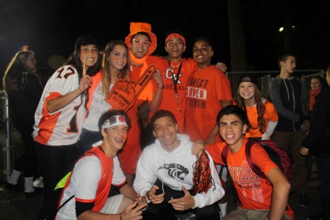 A group of fans wearing all orange and white to support their Cougs!