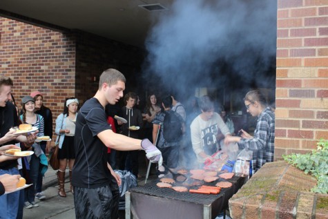 Matthew Plyler helping out by making burgers and hotdogs.