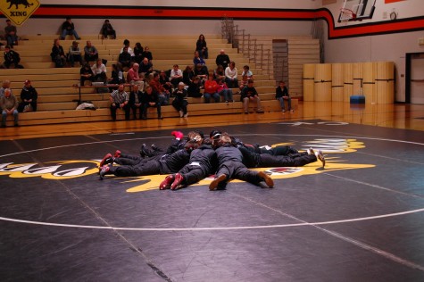 wrestling team huddles to get ready for their match