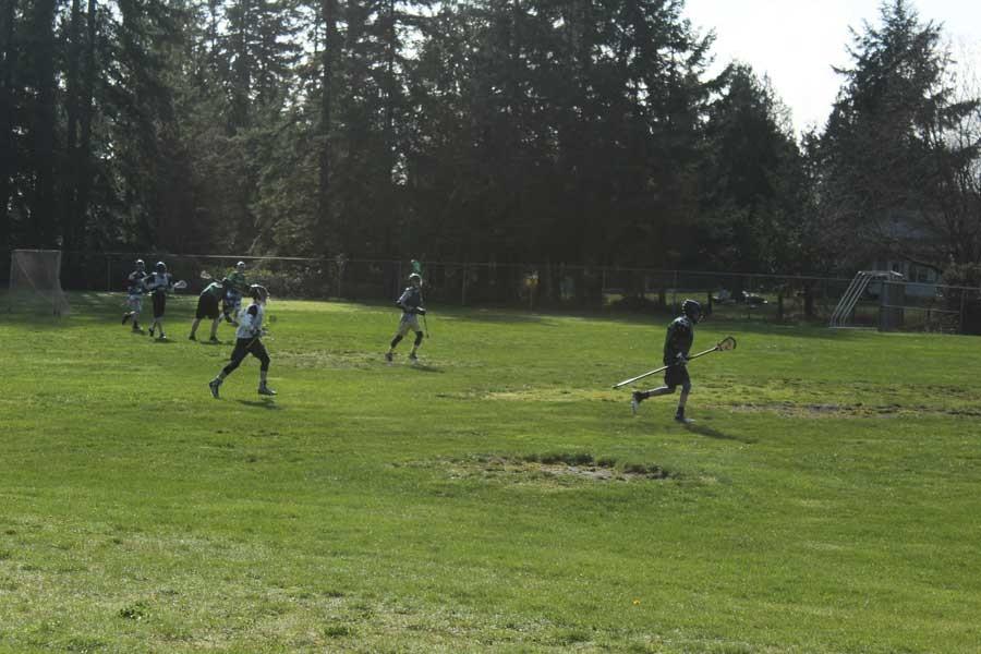 The Klahowya boys lacrosse team warmed up just before practice began.