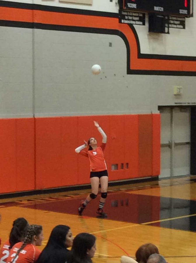 Leah Kunz serves the winning ball of the second period. Photo taken by Treys Neptune