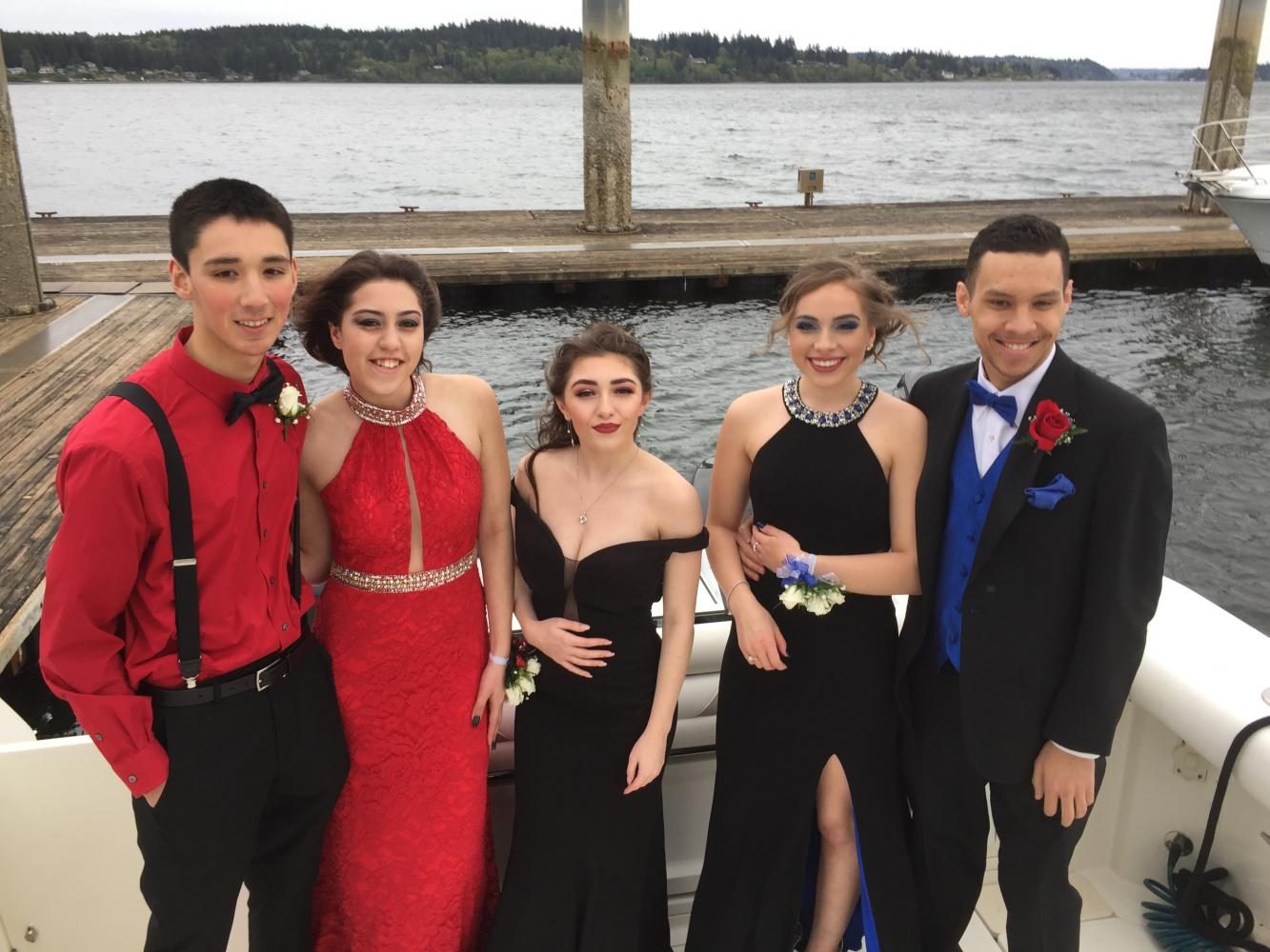 Seniors Cody Spiegel, Kaileigh Davila, Karlee Weninger, and Kendall Washington, with junior Adaleana Hunter on a boat at the Silverdale waterfront trying to not get blown away by the wind. 