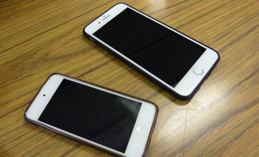 Student phones on a desk.