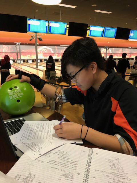 Leia Casal works diligently on homework during practice.
