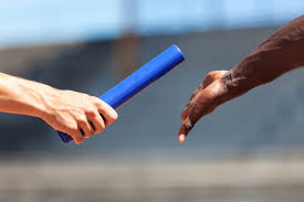 Two Track Athletes Passing the Baton