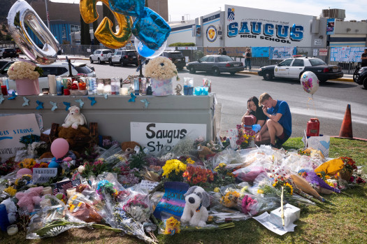 Saugus high students Katie Thanaet and Tyler Wilson look over items left at a memorial in front of the school Tuesday, November 19, 2019.  Students were allowed back on campus to collect their belongings left behind after the tragic shooting last Thursday.  Classes will resume at the high school on December 2nd. (Photo by David Crane, Los Angeles Daily News/SCNG)