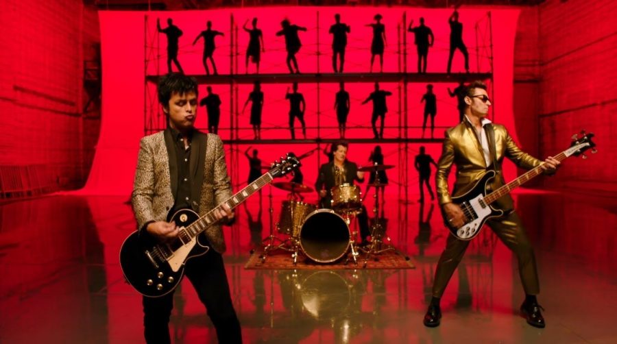 Guitarist Billie Joe Armstrong (left), drummer Tré Cool, and bass guitarist Mike Dirnt (right) pictured in the music video for “Father of All...” 
