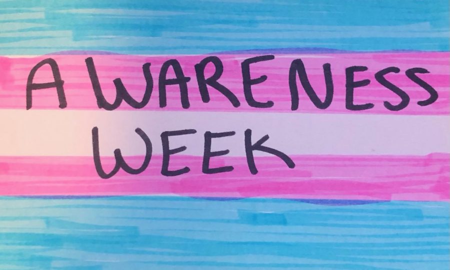 A hand-drawn transgender pride flag with "Awareness Week" written on it. 