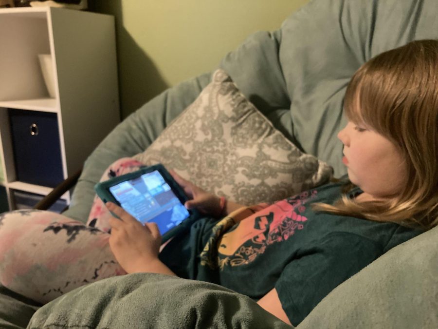 Third grade student of Cougar Valley Elementary school plays Among Us. on her tablet from the comfort of her own home. 