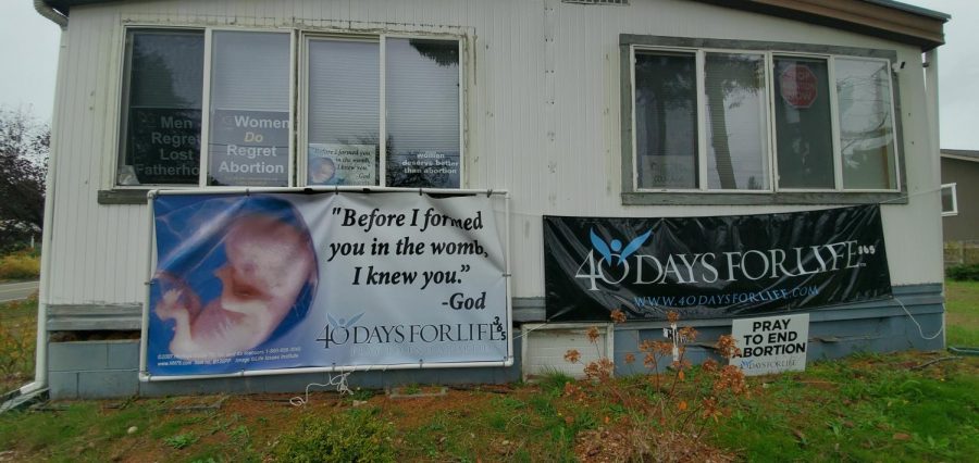 Several pro-life signs and posters are located across the street from Planned Parenthood. 