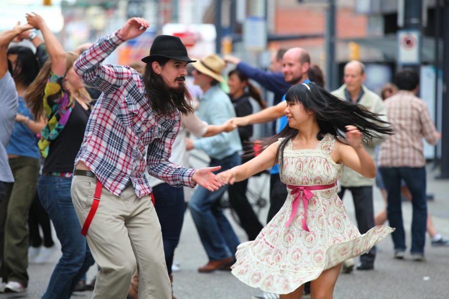 People engaging in the swing style of dance.