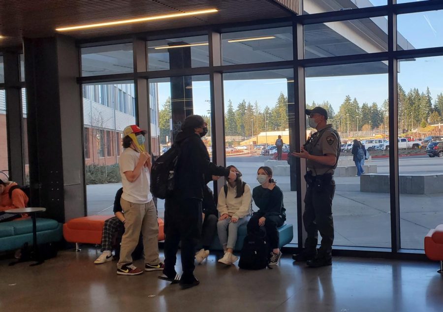 Deputy Manchester talks with a group of students after school lets out.