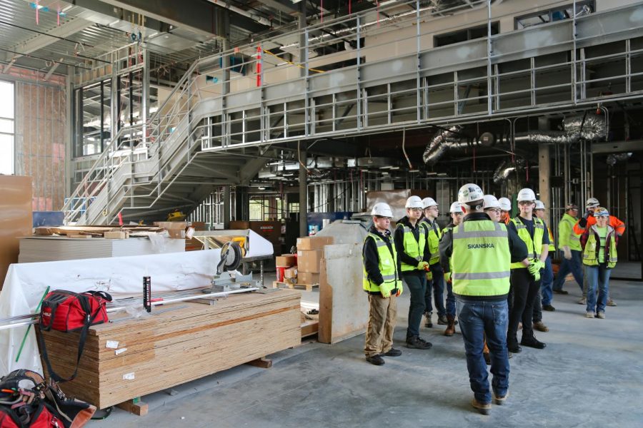 A group of construction workers gathered in the midst of a half-built CKHS.