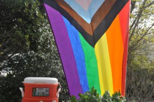 A vendor hangs a pride flag in show of support, despite not being allowed to hold celebrations. 