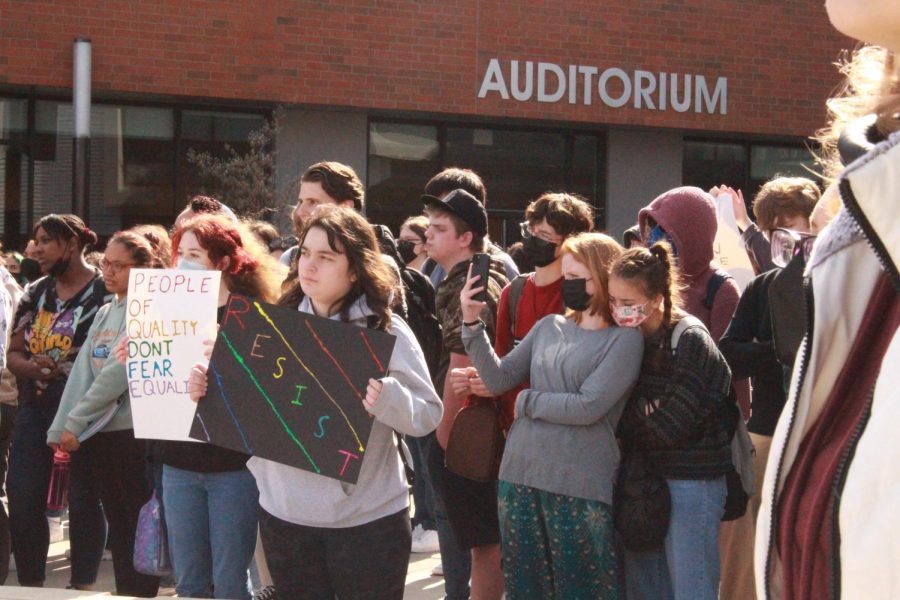 Students hold signs during the walkout. 