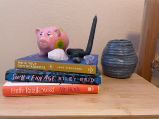 A variety of crystals resting on a stack of books. 