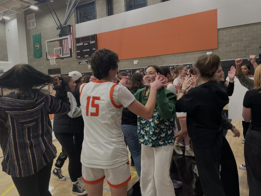 Emma and Abi Lundblad sharing a moment after girls basketball secures their win