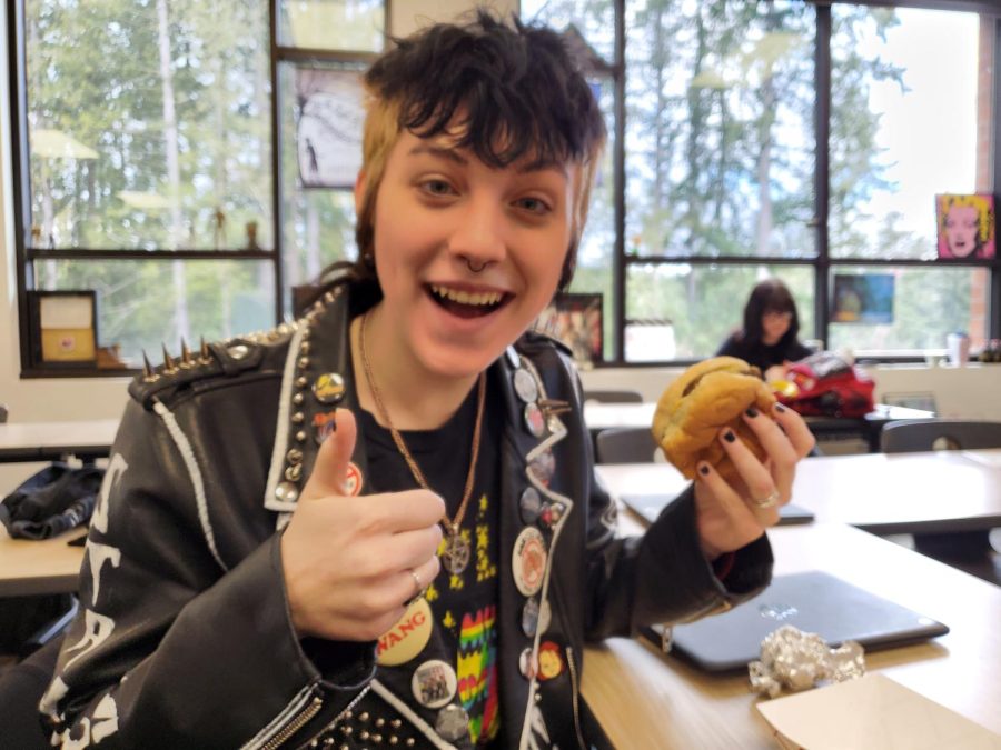 Bo O’Shaughnessy poses with his cheeseburger in Mr. Tracewell’s classroom. Many students choose to eat lunch in places other than the cafeteria due to overcrowding.