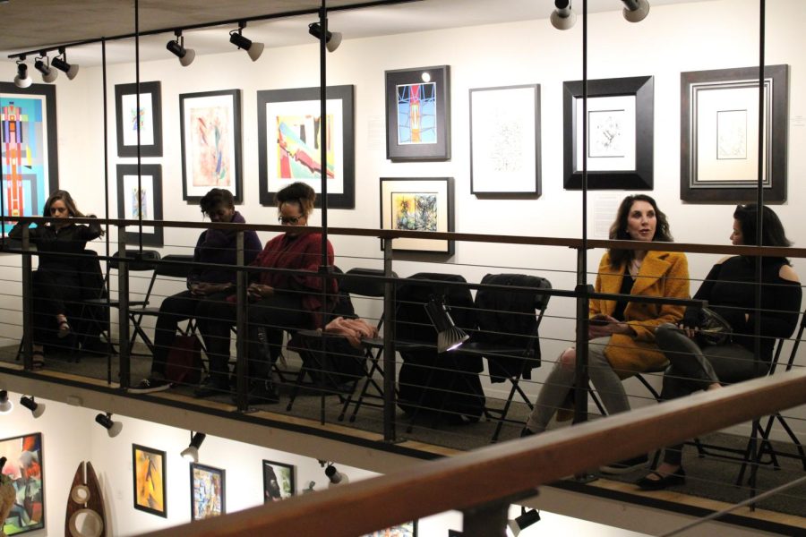 Audience members at the Fredrick Holmes and Company gallery converse and enjoy the art around the room before the night of culture and music begins.