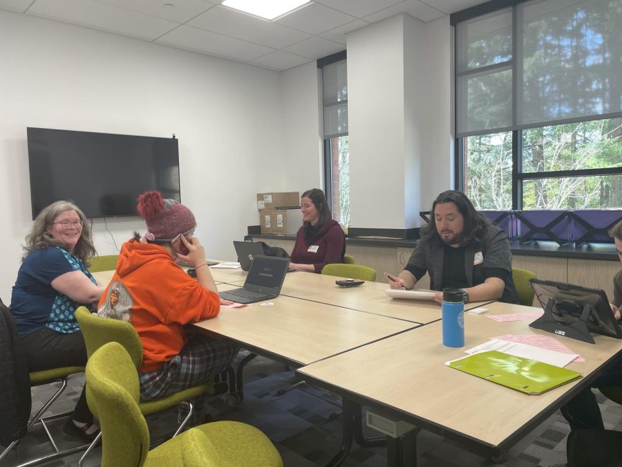 Anna Fulford, Chris Oizer, and Promise Partner holding a help group session for financial aid.