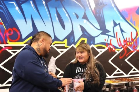 Elizabela Camacho receiving an award for her work with Gods Broken Home University, handed By Monk Tupai. Used with permission from Christina Roark Photography.