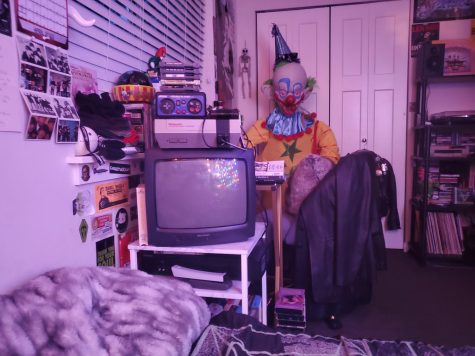 Pictured is my CRT (or tube) TV positioned across from my bed. A Nintendo Entertainment System (NES) sits atop it, and a dual-deck DVD/VCR is below. 