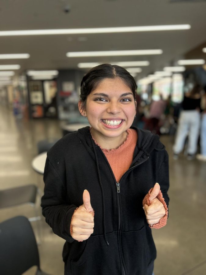 Ambar Gaxiola poses with two thumbs up for her portrait.