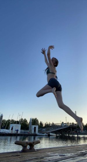 Solenn Gendreau pictured jumping off of the dock into Dyes Inlet at the Silverdale Waterfront.
