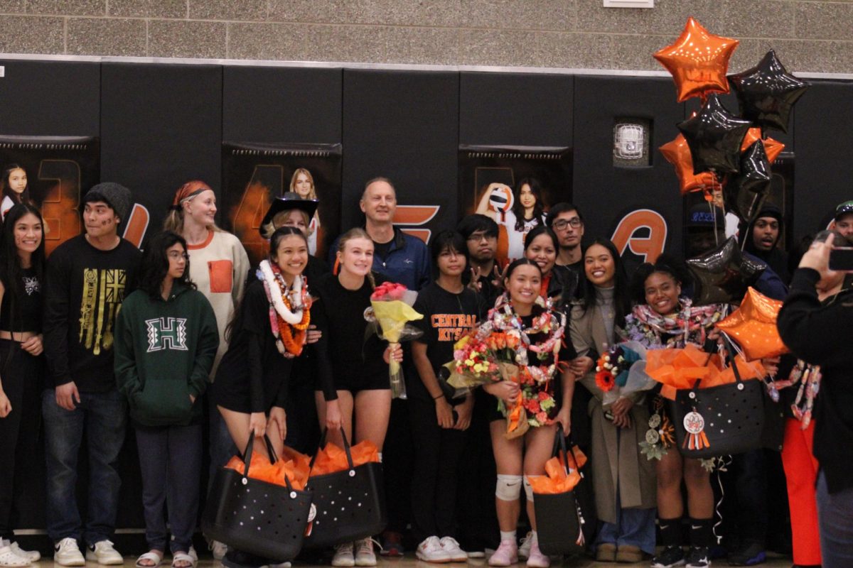 Players and their families share gifts and smiles before their final home volleyball game.
