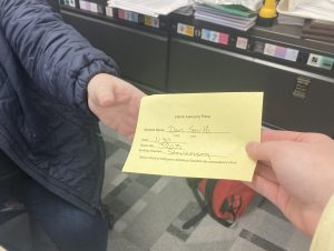 Advisory pass being handed to history teacher Ms. Szczepanski. 