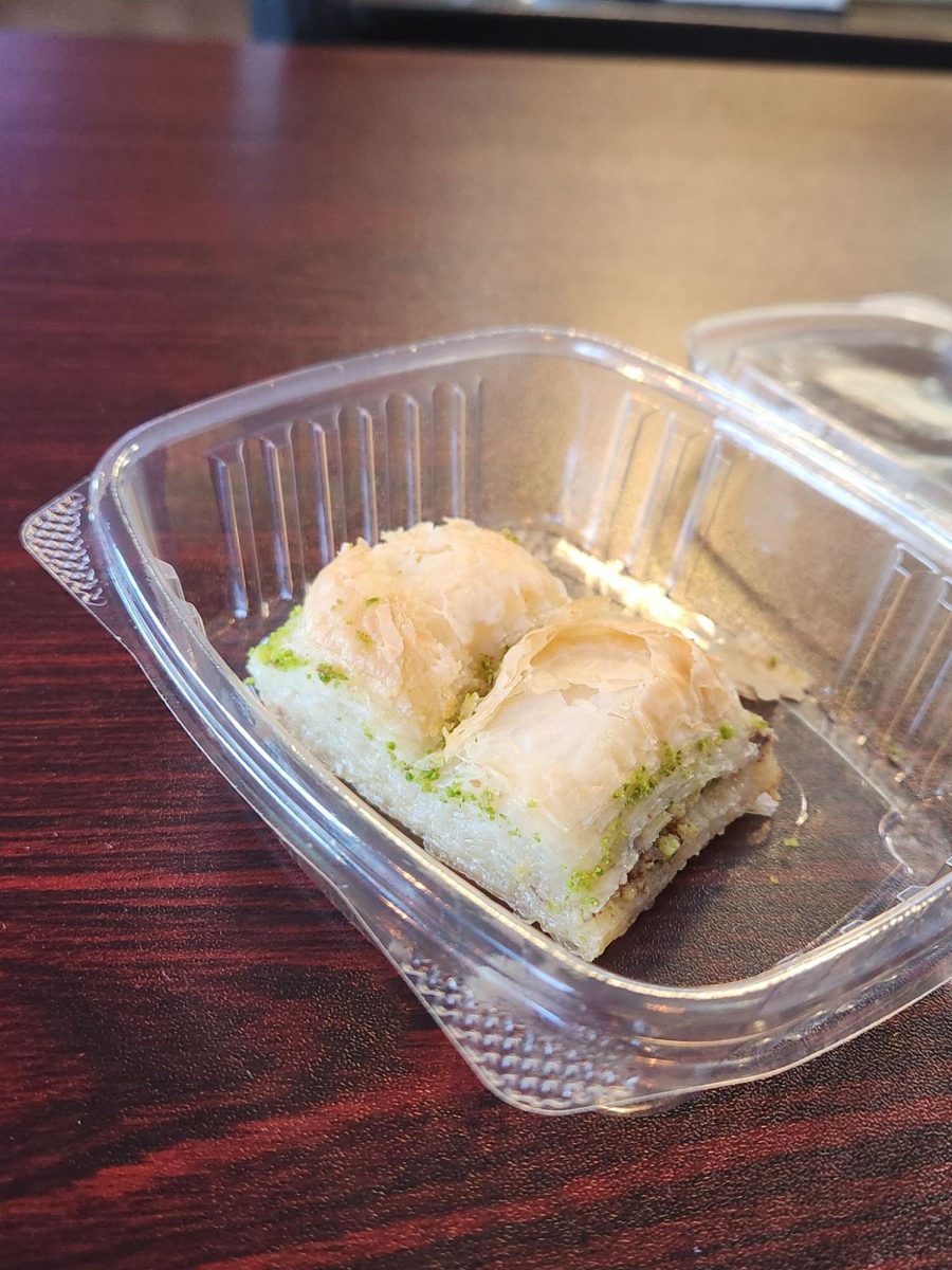 Pistachio baklava: a sweet, flaky pastry made with layers of phyllo dough, filled with chopped nuts and soaked in syrup or honey.
