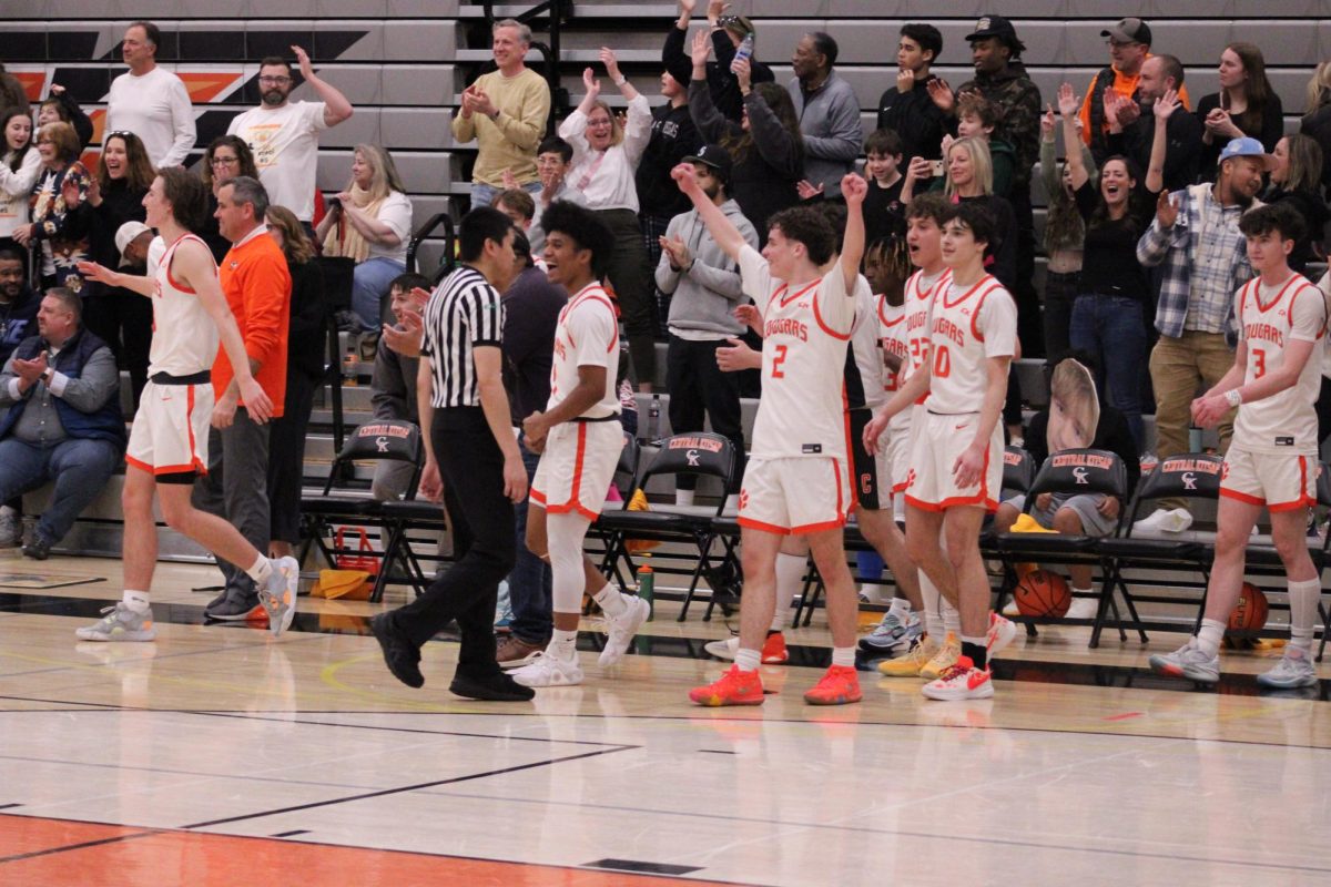 Boys Basketball team celebrate a win during the final seconds of the game.