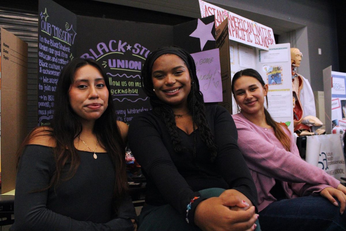 BSU Members Jareth Hilario (Left), Gabrielle Dockendorf (Middle) and Haley Borja (Right) all sitting in front of the BSU table at MAZE Day