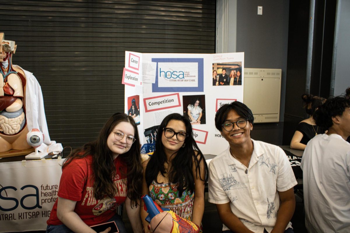 Gwen Maldonado (left) Kaela Ysabel Rivera (center) and Cadeance Nitura-Corpuz (right) posing in front of their trifold