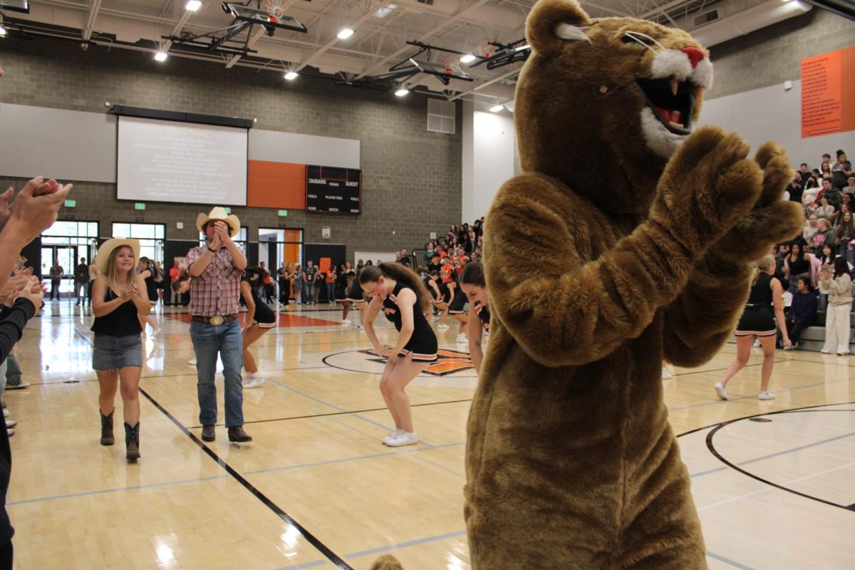 Sophomore ASB representatives Reese Albin and Lucas Smith hyping up the crowd with Cirillo during the class introduction.
