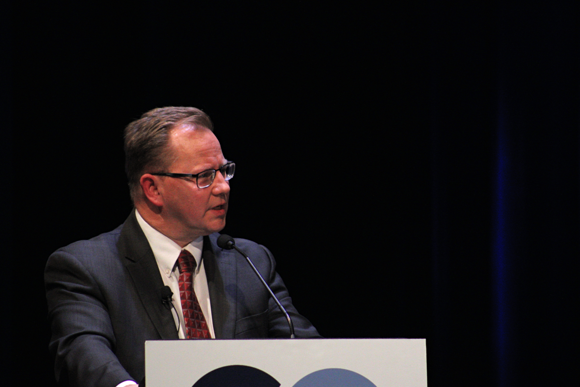 Chris Reykdal answering the moderator's question during the debate. 