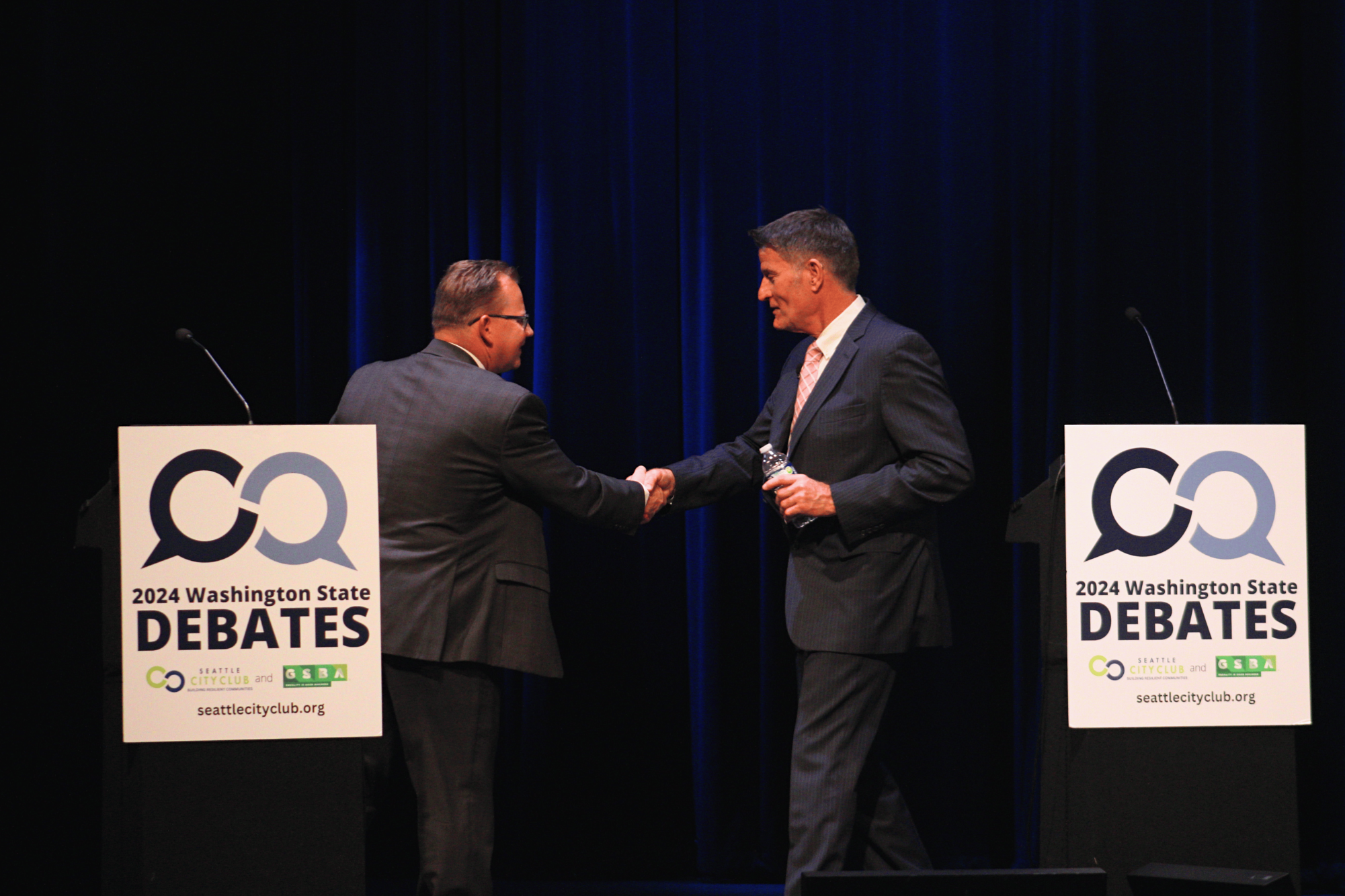 Chris Reykdal (Left) and David Olson (right) shaking hands at the end of the debate. 