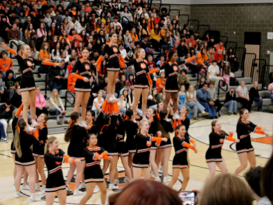 CKHS varsity cheer team stunting at the 2024-2025 homecoming assembly.