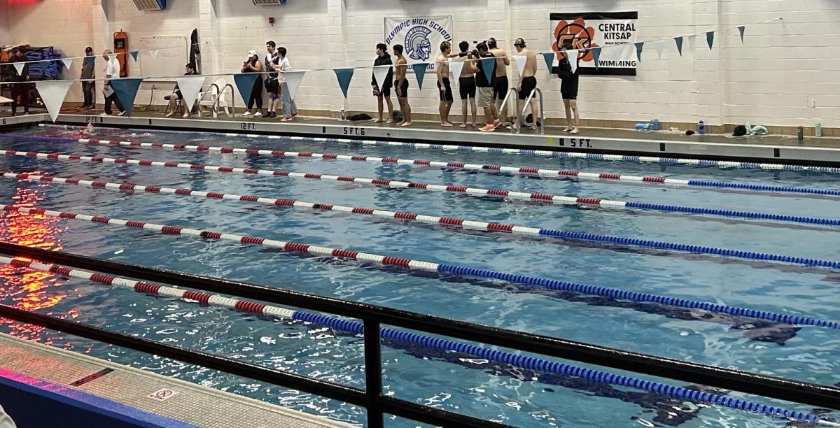 Olympic High Schools Aquatic Center pool after Event 7, with a group of Central Kitsaps Boys Swim team looking for their next event(s).