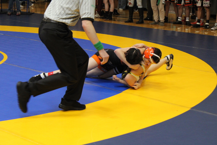 Madeline Johnson pins her opponent during her match at a Bremerton High school wrestling tournament.