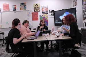 President Zee Gemmer (Center) works with members of GSA to create bracelets for an upcoming fundraiser.