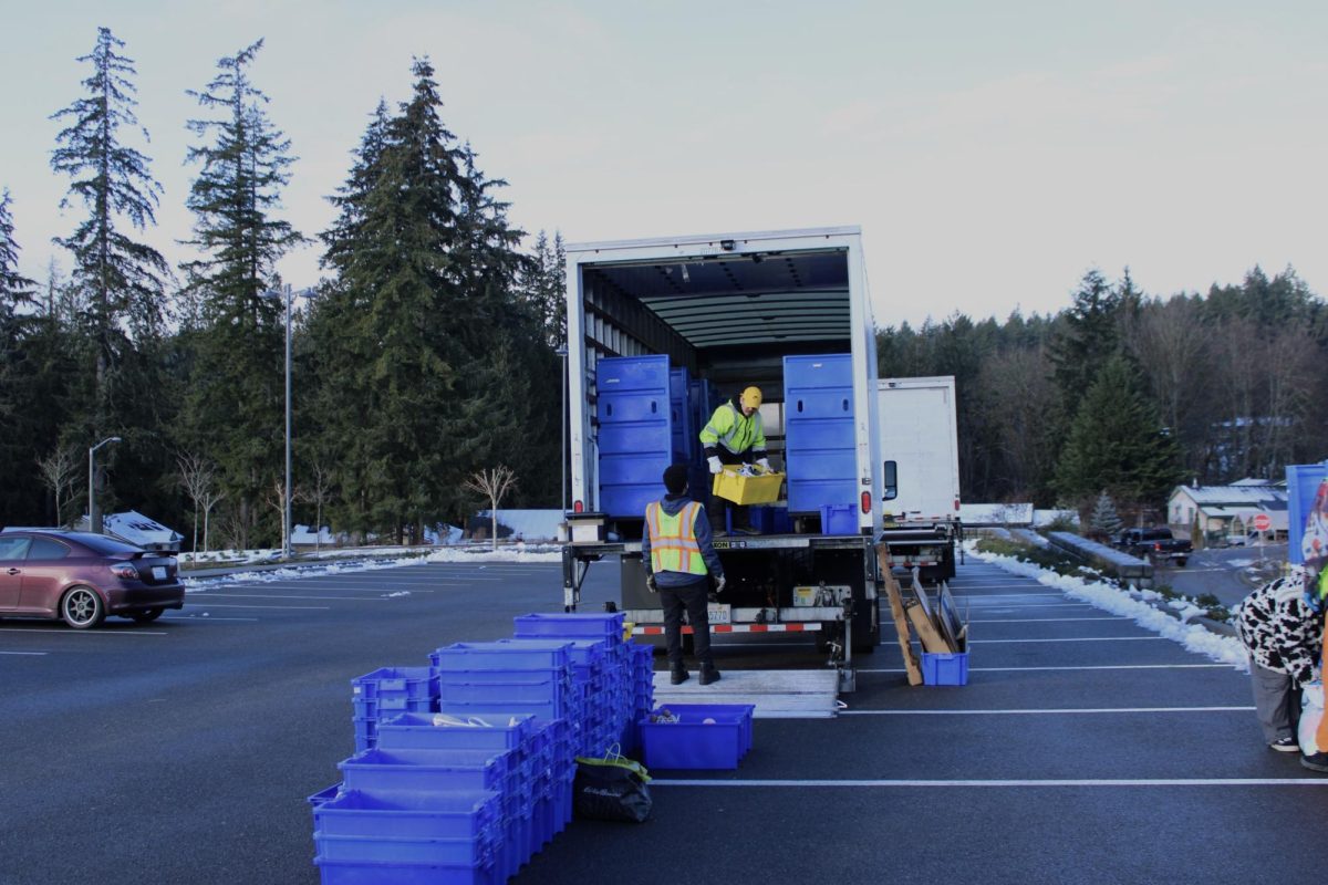 Evergreen Goodwill employees fill the truck with donations.