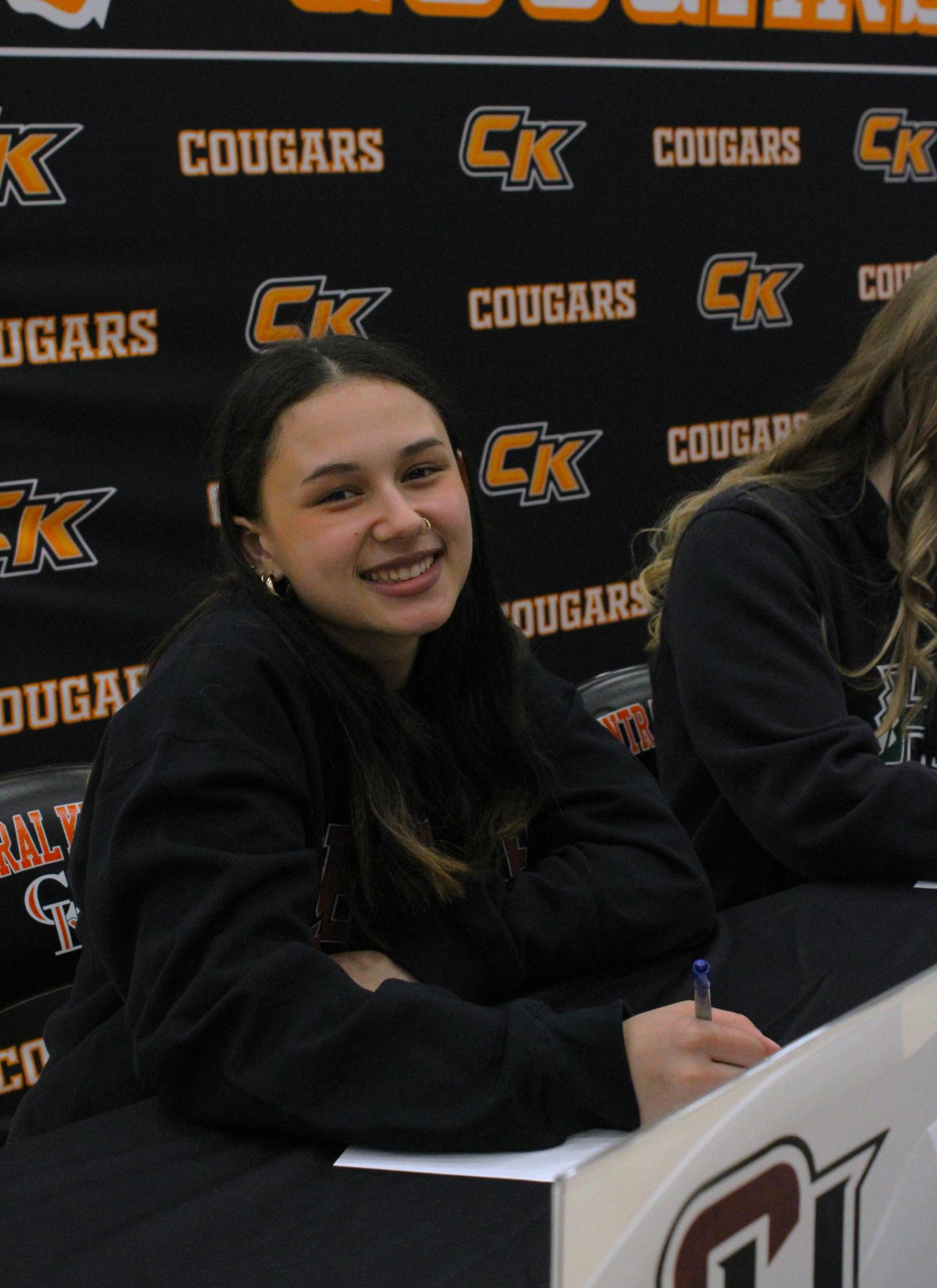 Swim athlete Haley Borja smiles for a photo during the signing event. 