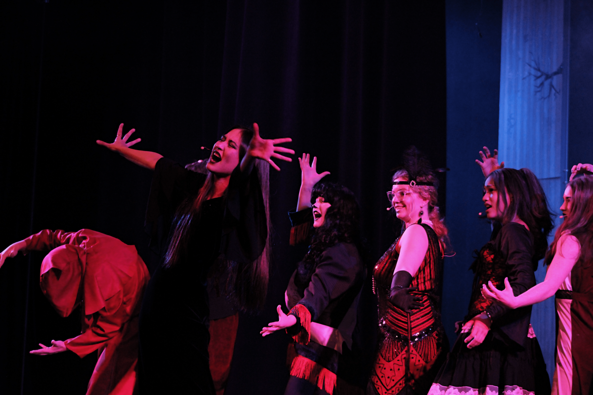 Morticia Addams (Jennaveve Hernandez) sings solo by a parade of ancestors.