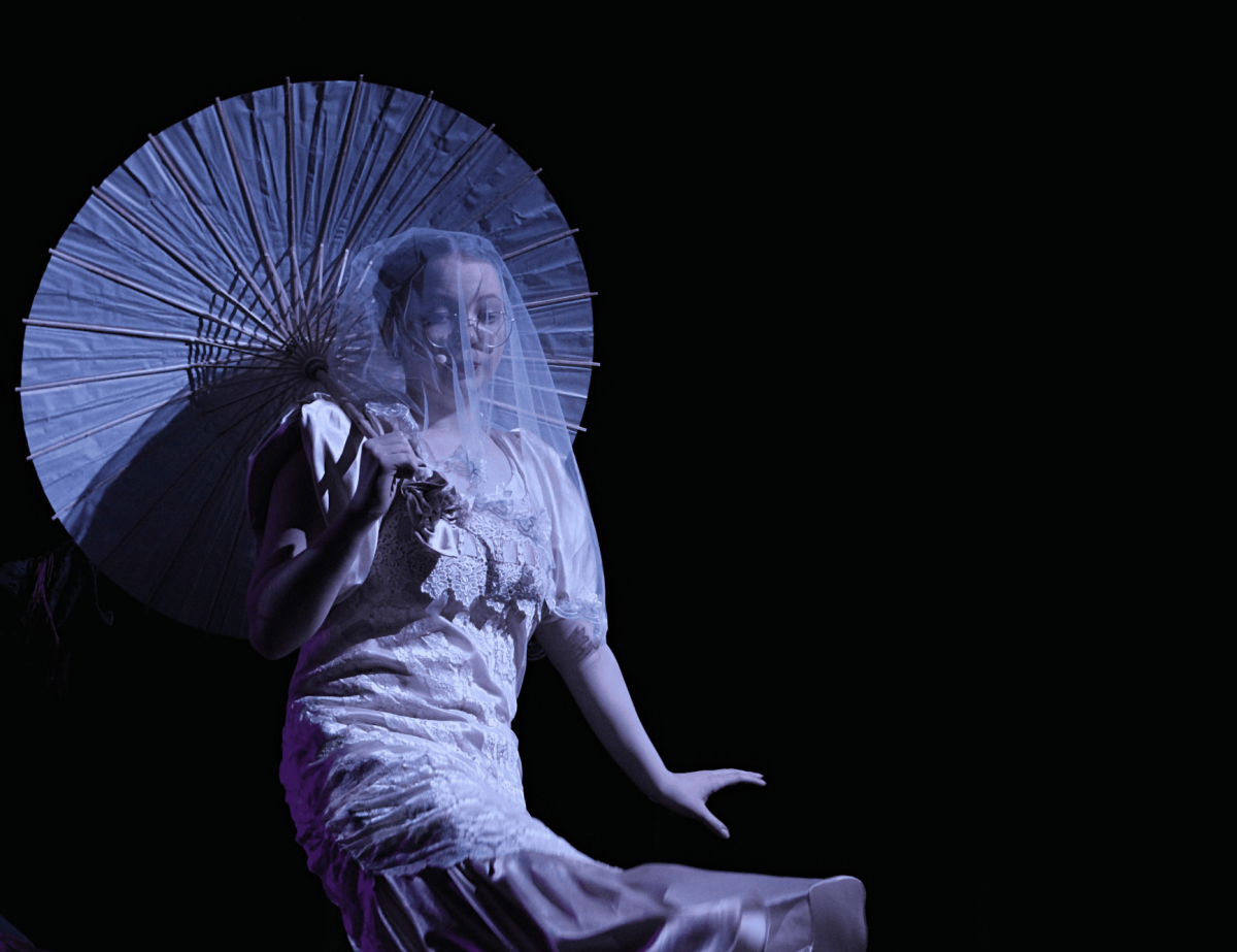 A widowed Addams ancestor (Dani-lou Gemmer) parades a parasol in the moonlight.