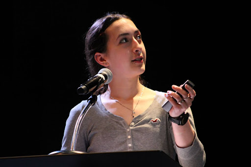 Jazmyn Budke presents her project to the audience in the Performing Arts Center. 
