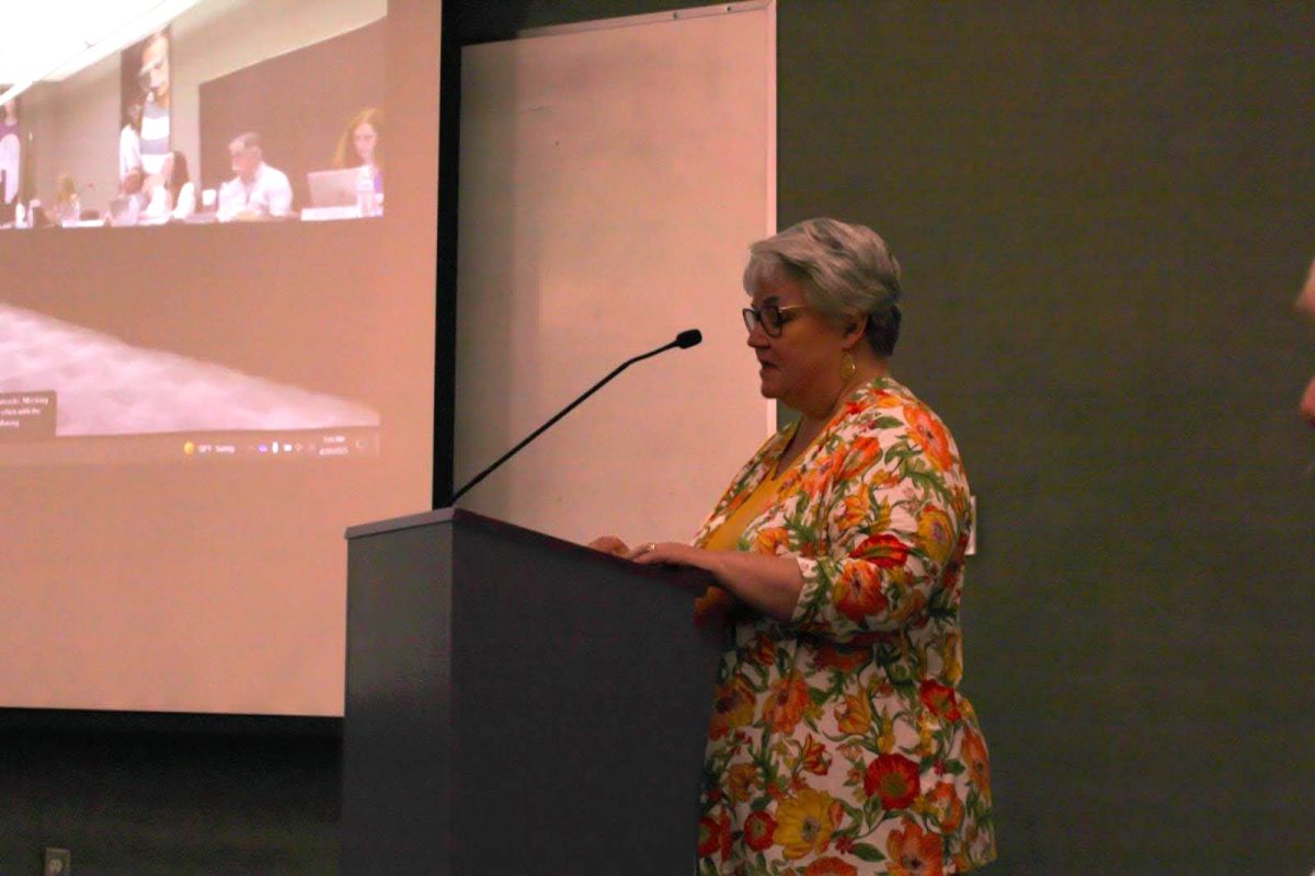 Special education collaborative teacher Martha Patterson speaks to the board during the public comment section.