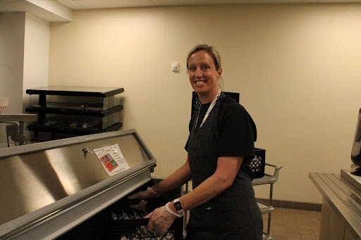 Kelly Patterson puts a crate of clean utensils away.