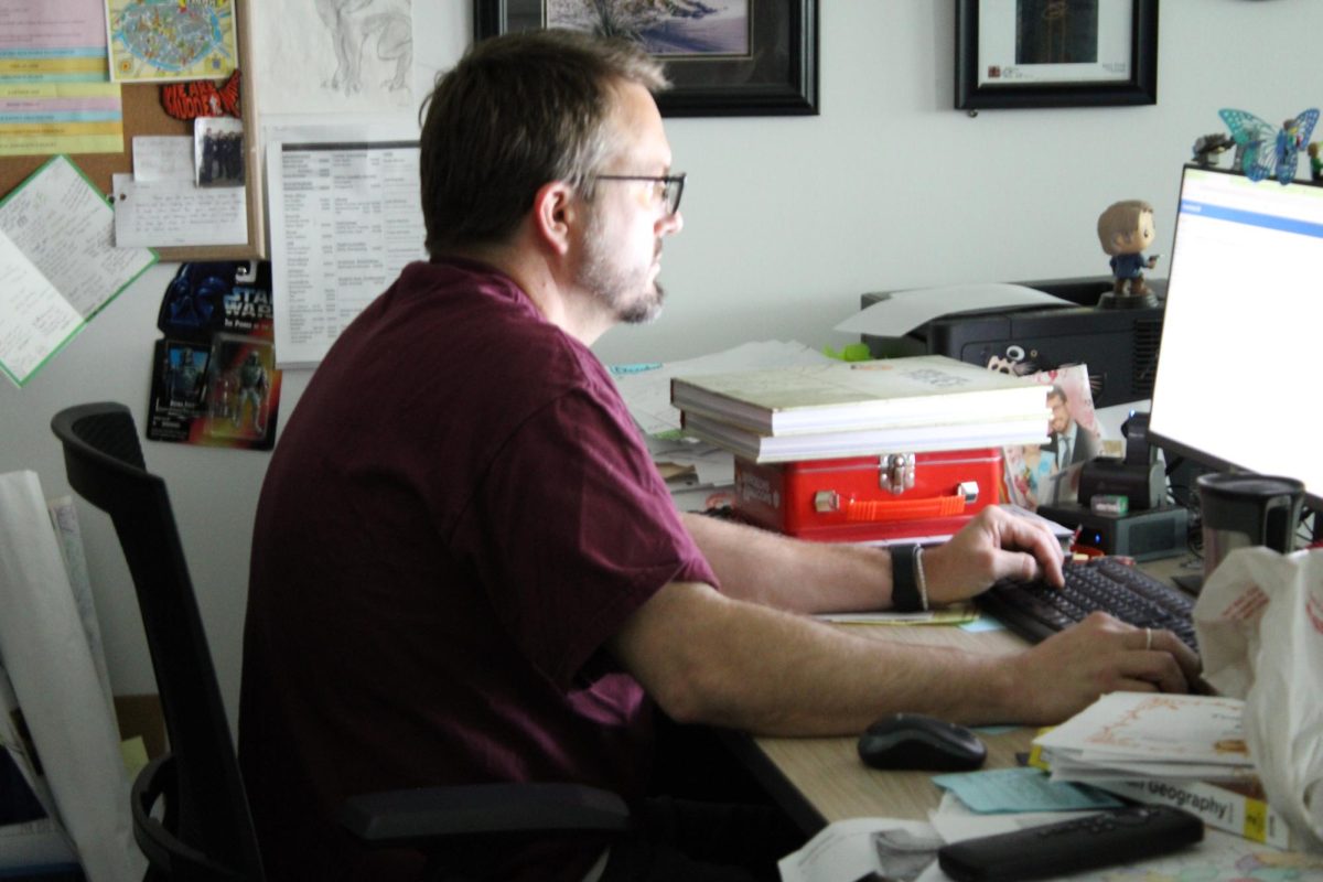 Chris Kassler works at his desk during the school day.
